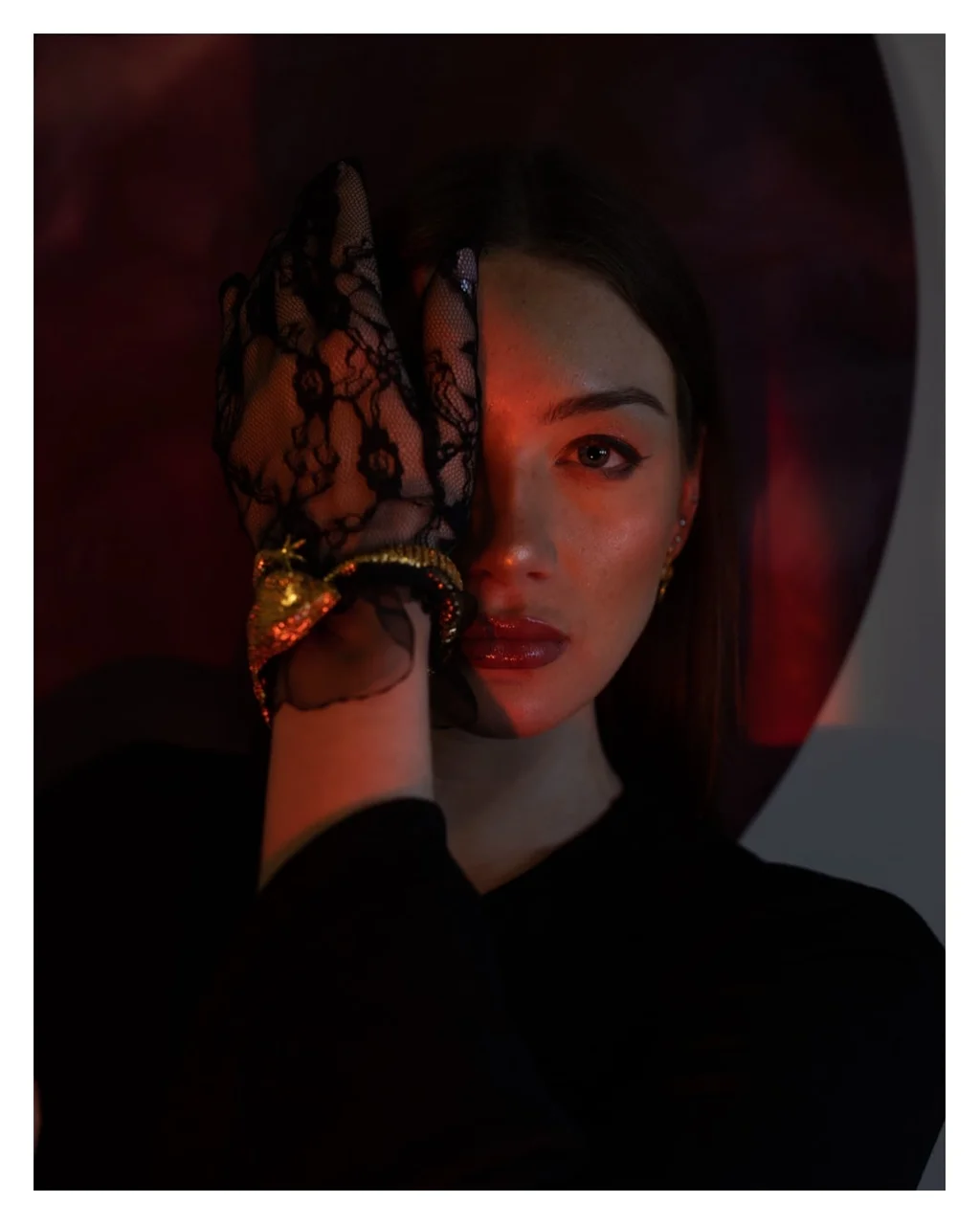Portrait with a lace glove and a red reflection across the face