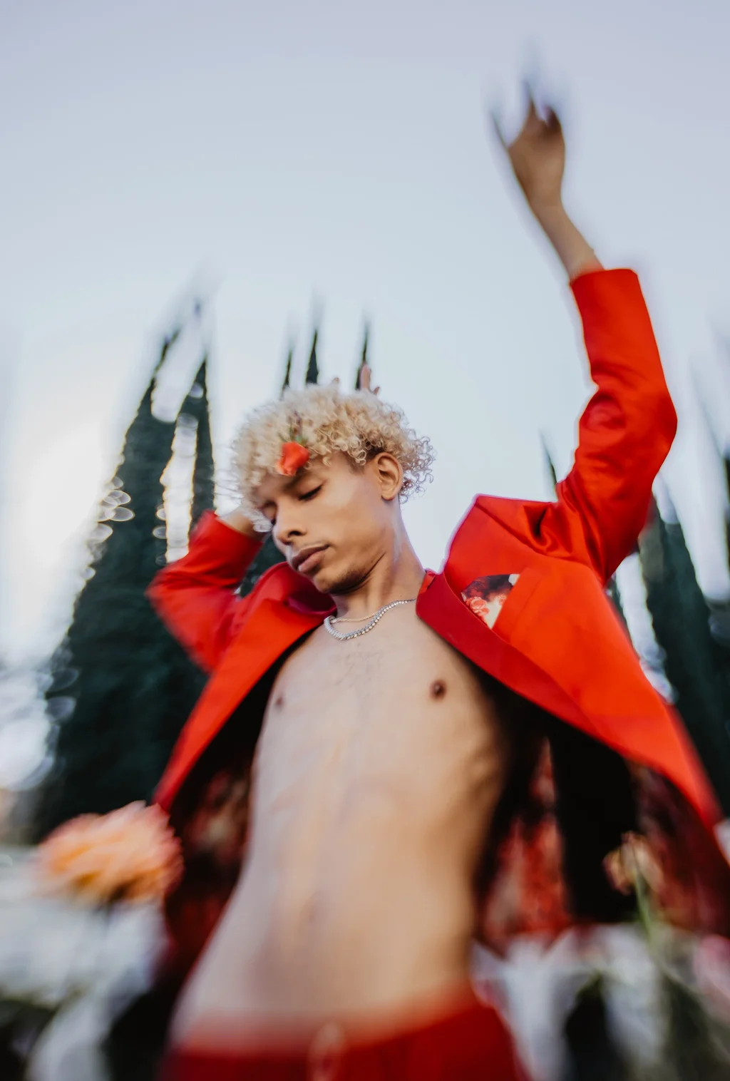 A red jacket and raised arms caught in motion